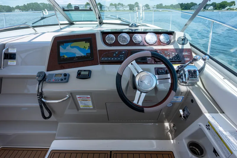 Latitude Adjustment Yacht Photos Pics Cockpit of 2013 Sea Ray 370 Sundancer with navigation system and steering wheel.