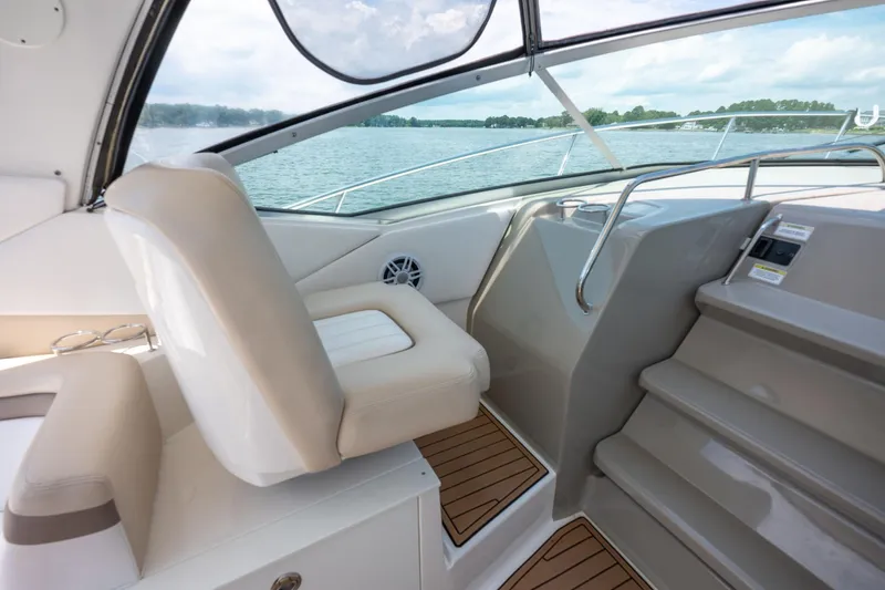 Latitude Adjustment Yacht Photos Pics Interior view of 2013 Sea Ray 370 Sundancer boat, featuring helm seat and steps.