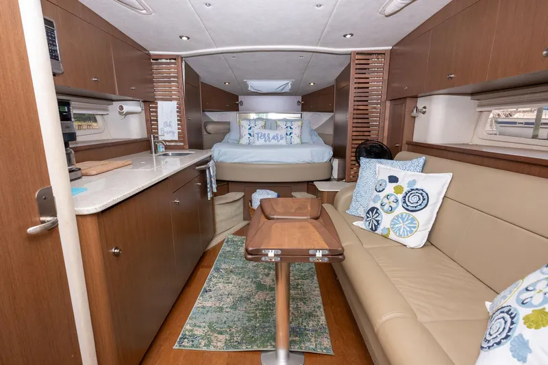 Latitude Adjustment Yacht Photos Pics Luxurious interior of 2013 Sea Ray 370 Sundancer yacht with cozy seating and elegant decor.