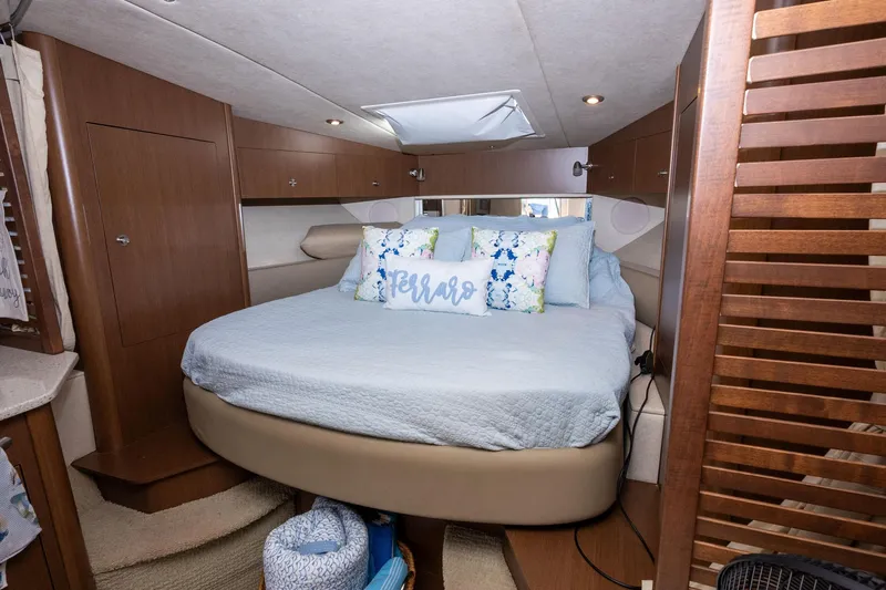 Latitude Adjustment Yacht Photos Pics Cozy bedroom interior of 2013 Sea Ray 370 Sundancer yacht with plush bedding and wooden accents.