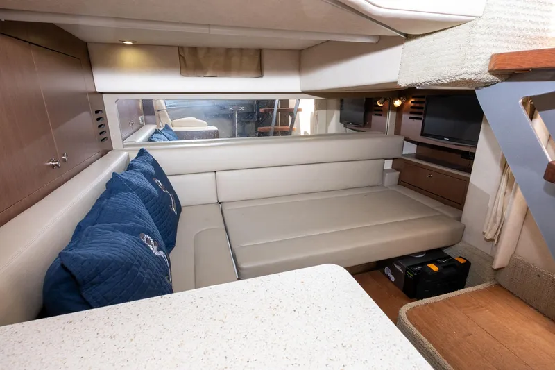 Latitude Adjustment Yacht Photos Pics Interior of 2013 Sea Ray 370 Sundancer with beige seating and blue cushions.
