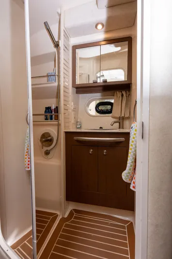Latitude Adjustment Yacht Photos Pics Bathroom interior of 2013 Sea Ray 370 Sundancer yacht, featuring shower and vanity.