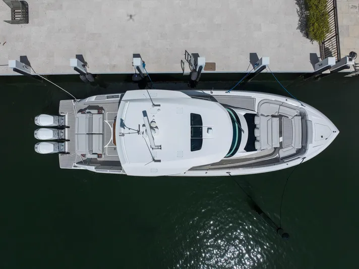  Yacht Photos Pics Aerial view of 2023 Tiara Yachts 48 LS docked, showcasing sleek design and triple engines.