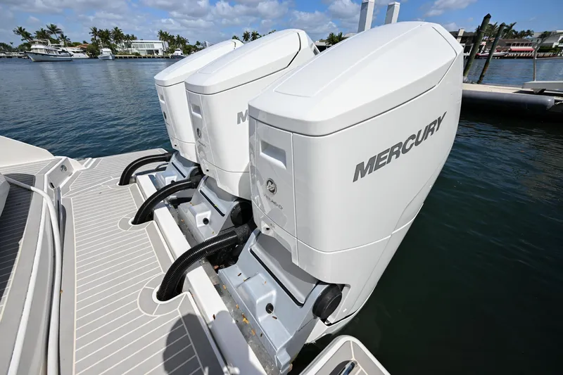  Yacht Photos Pics 2023 Tiara Yachts 48 LS with dual Mercury outboard engines on a sunny day.