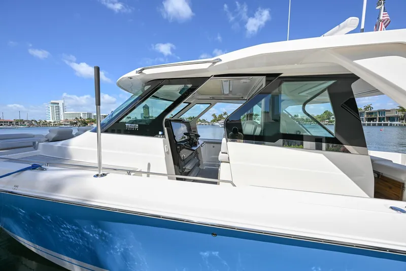  Yacht Photos Pics 2023 Tiara Yachts 48 LS, sleek design, docked under clear blue sky.