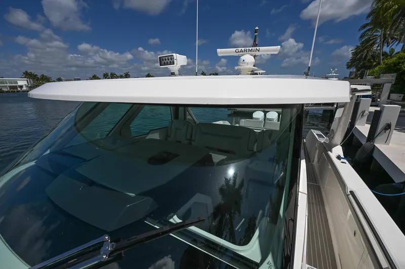  Yacht Photos Pics 2023 Tiara Yachts 48 LS docked, featuring sleek design and advanced Garmin navigation system.