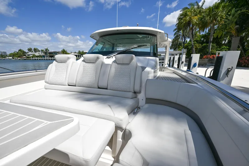  Yacht Photos Pics 2023 Tiara Yachts 48 LS luxury yacht with plush seating and scenic waterfront view.