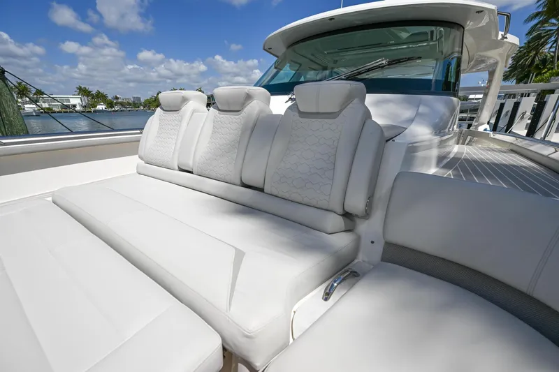  Yacht Photos Pics 2023 Tiara Yachts 48 LS luxury seating with white cushions, under a clear blue sky.