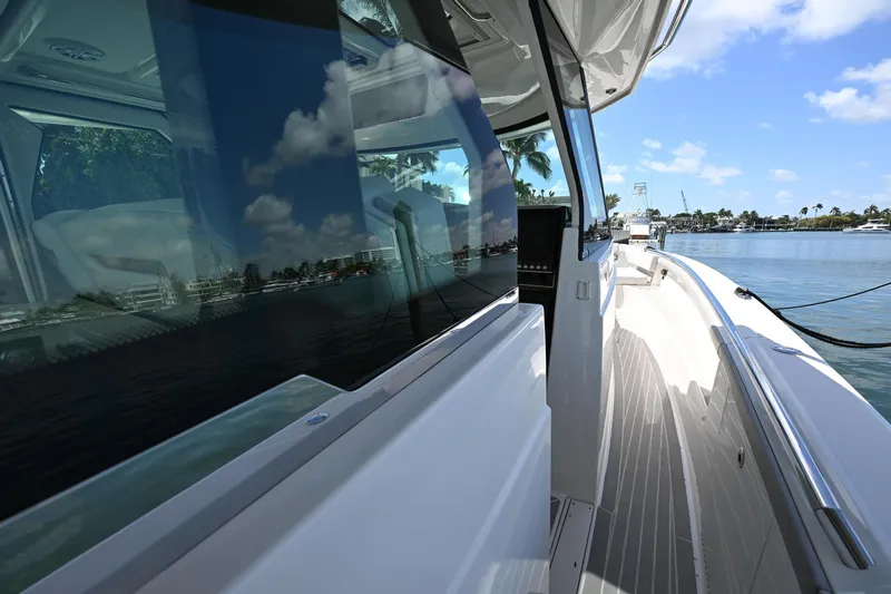  Yacht Photos Pics 2023 Tiara Yachts 48 LS, sleek deck view with waterfront reflections.