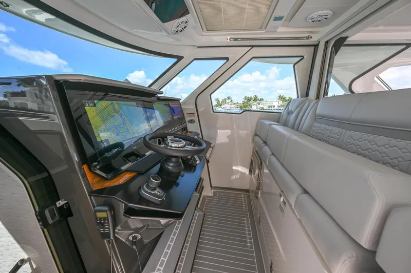  Yacht Photos Pics 2023 Tiara Yachts 48 LS interior with modern helm and luxurious seating.