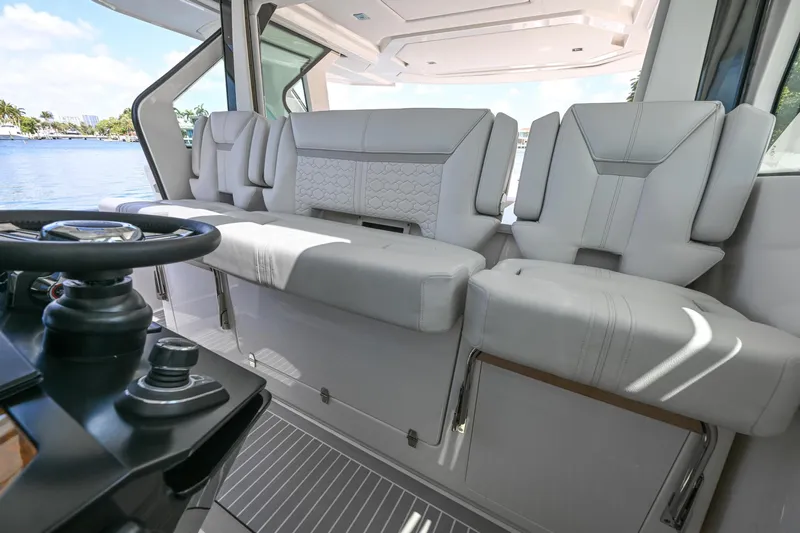  Yacht Photos Pics 2023 Tiara Yachts 48 LS interior with luxurious seating and modern helm controls.