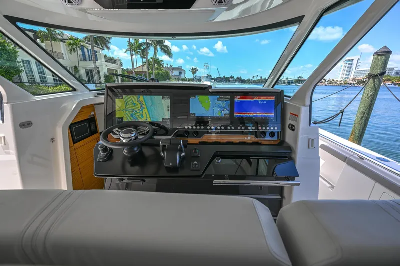  Yacht Photos Pics 2023 Tiara Yachts 48 LS helm with advanced navigation systems and waterfront view.