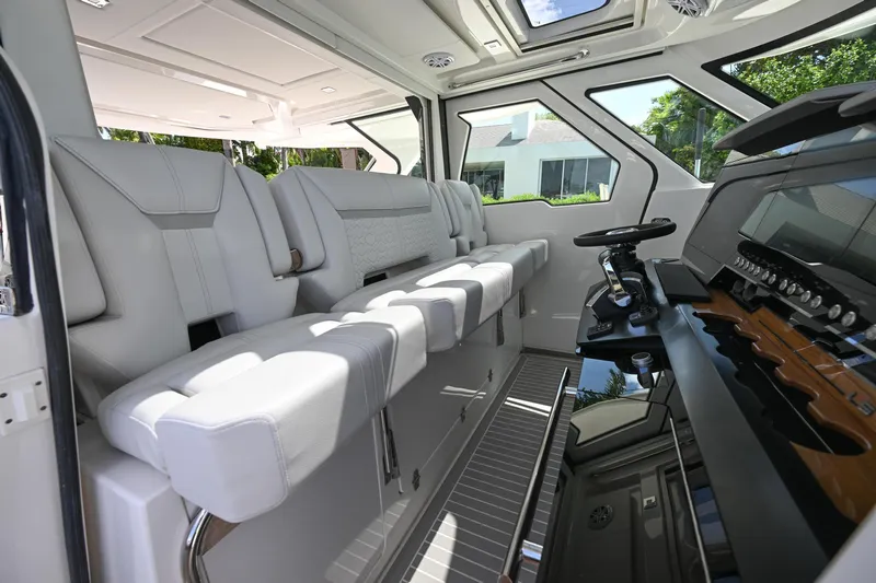  Yacht Photos Pics 2023 Tiara Yachts 48 LS interior with luxurious seating and modern helm controls.