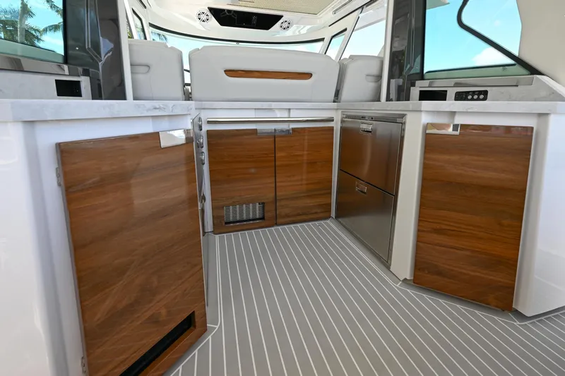 Yacht Photos Pics 2023 Tiara Yachts 48 LS interior with sleek wood cabinetry and modern design.