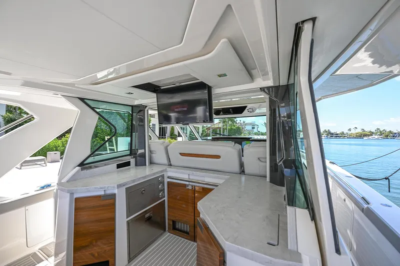  Yacht Photos Pics 2023 Tiara Yachts 48 LS interior with modern kitchen and waterfront view.