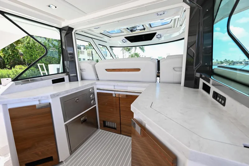  Yacht Photos Pics Luxurious interior of 2023 Tiara Yachts 48 LS, featuring modern kitchen and seating area.
