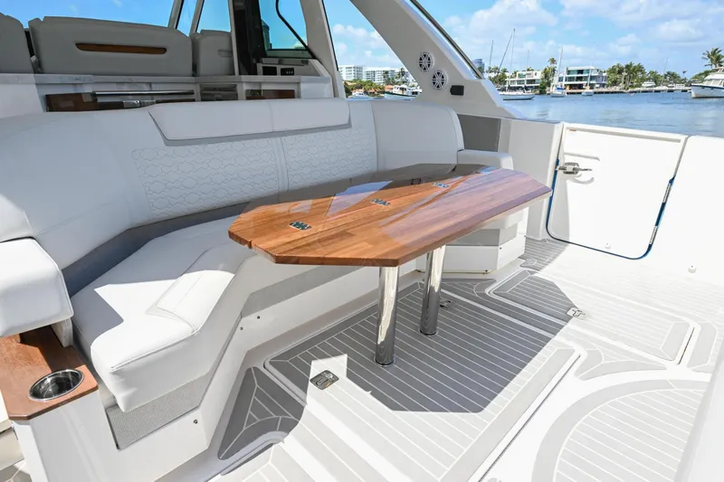  Yacht Photos Pics Luxurious 2023 Tiara Yachts 48 LS interior with elegant seating and wooden table.