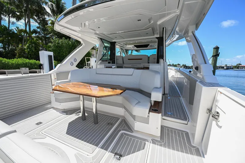  Yacht Photos Pics 2023 Tiara Yachts 48 LS luxury yacht interior with sleek seating and elegant wooden table.