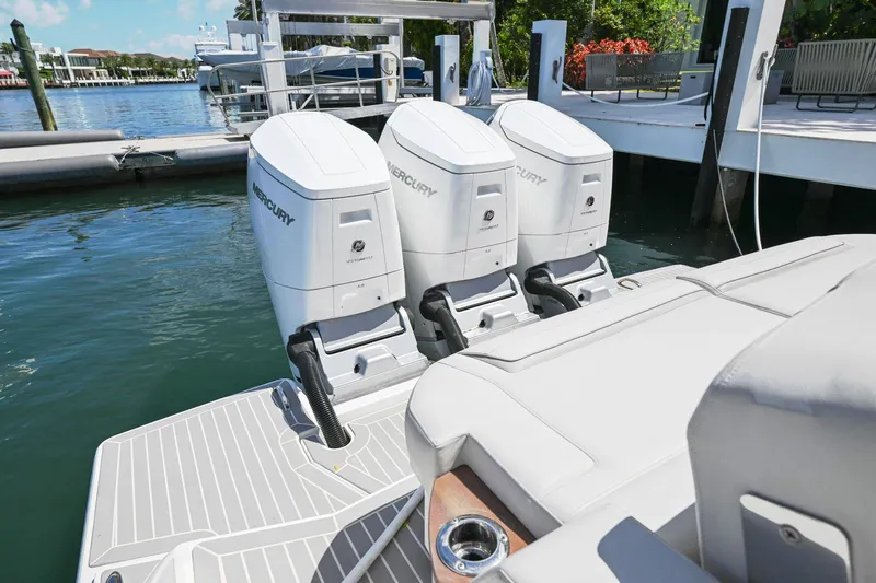  Yacht Photos Pics 2023 Tiara Yachts 48 LS with triple Mercury outboard engines docked at marina.
