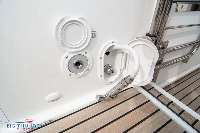  Yacht Photos Pics 2024 Jeanneau Leader 9.0 WA boat deck with hose and fittings.
