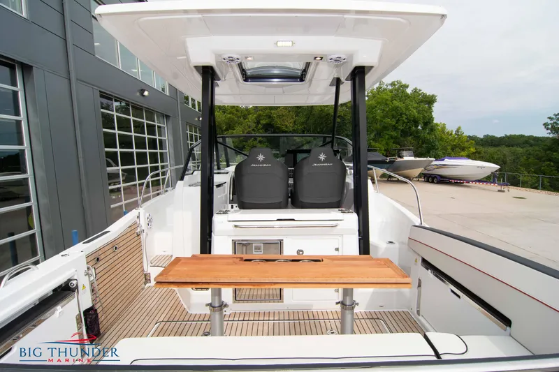  Yacht Photos Pics 2024 Jeanneau Leader 9.0 WA boat interior with seating and table, docked at marina.