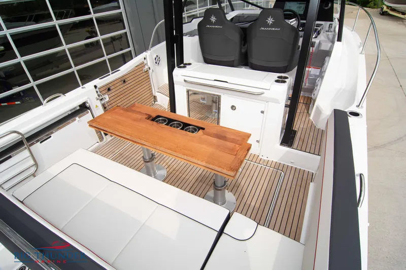 Yacht Photos Pics 2024 Jeanneau Leader 9.0 WA boat interior with seating and wooden table.
