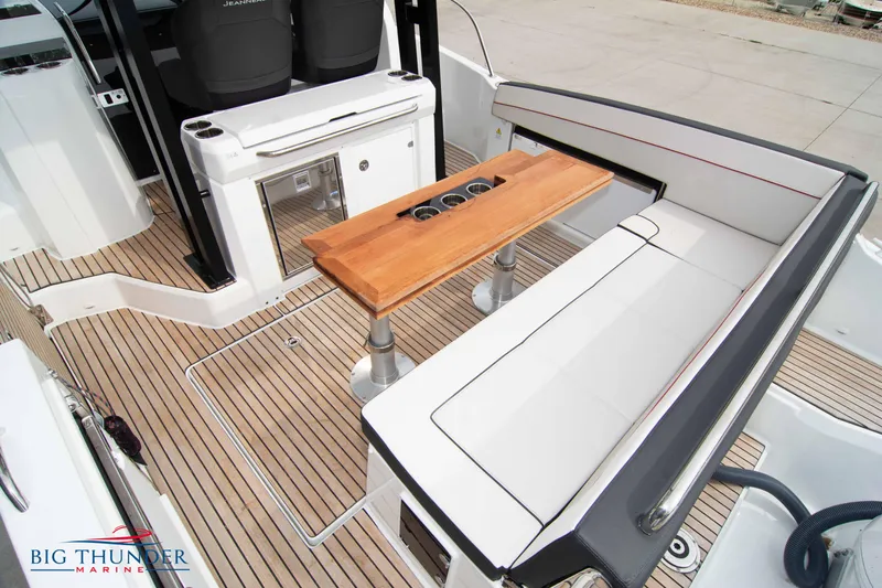  Yacht Photos Pics 2024 Jeanneau Leader 9.0 WA boat interior with seating and wooden table.