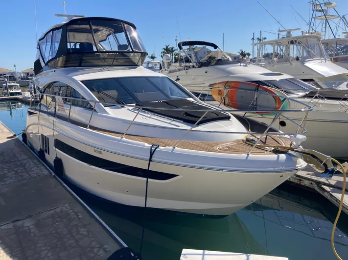  Yacht Photos Pics 2018 Sea Ray Fly 510 yacht docked in marina under clear blue sky.