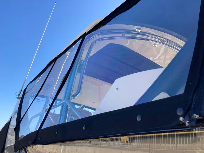  Yacht Photos Pics 2018 Sea Ray Fly 510 yacht with clear enclosure under a blue sky.