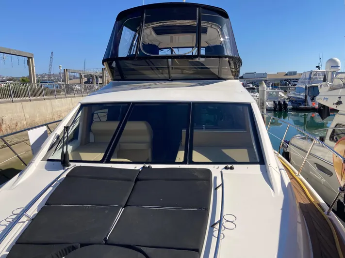  Yacht Photos Pics 2018 Sea Ray Fly 510 yacht docked at marina under clear blue sky.