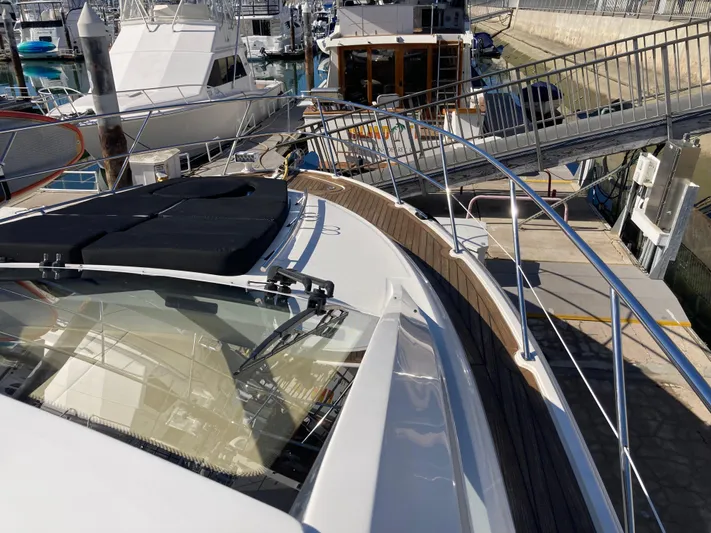  Yacht Photos Pics 2018 Sea Ray Fly 510 yacht docked at marina, showcasing sleek design and spacious deck.