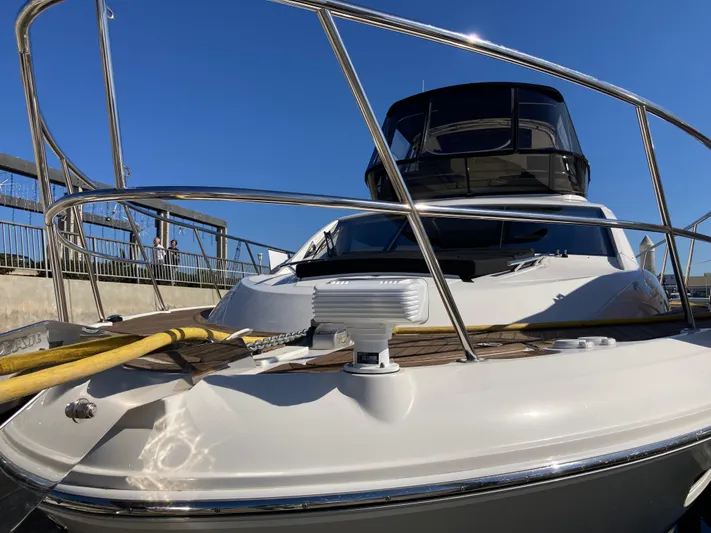  Yacht Photos Pics 2018 Sea Ray Fly 510 yacht docked under clear blue sky.