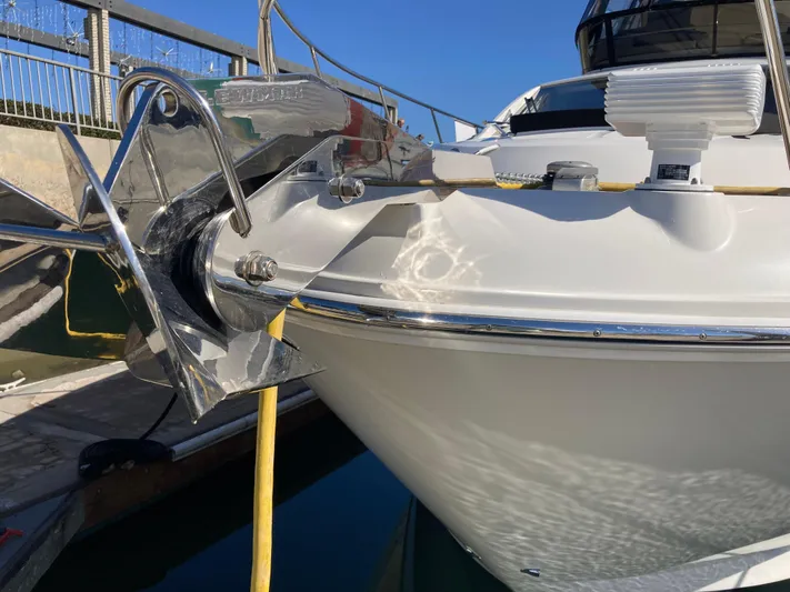  Yacht Photos Pics 2018 Sea Ray Fly 510 yacht bow with anchor, docked under clear blue sky.