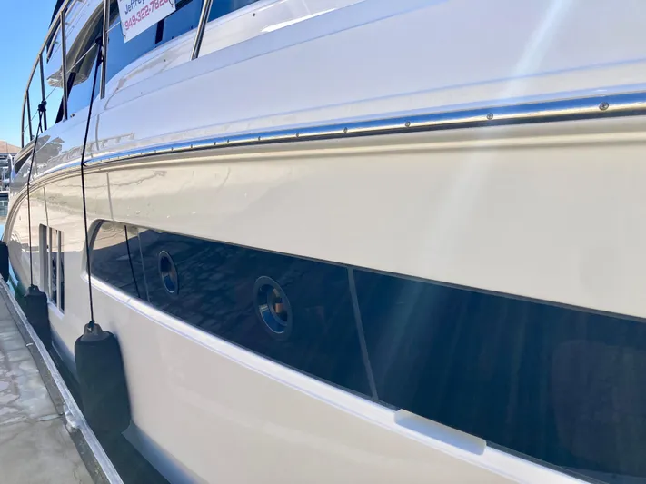  Yacht Photos Pics 2018 Sea Ray Fly 510 yacht docked, showcasing sleek design and polished exterior.