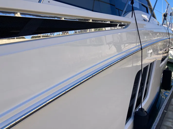  Yacht Photos Pics 2018 Sea Ray Fly 510 yacht side view with sleek white exterior.