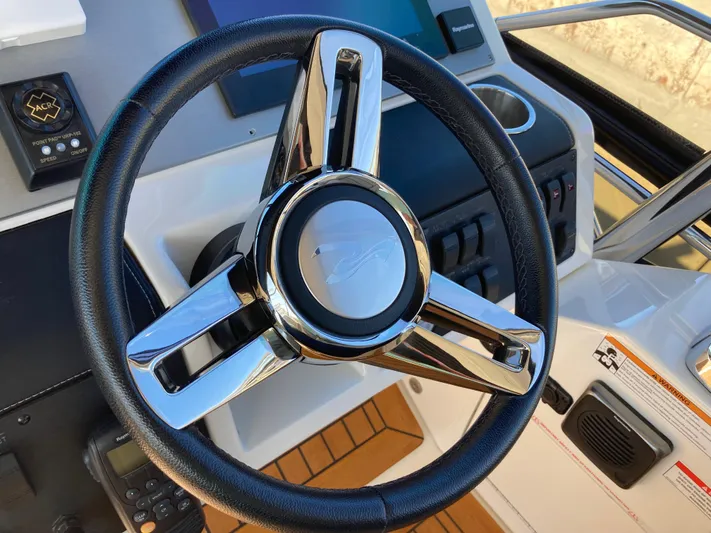  Yacht Photos Pics Steering wheel of 2018 Sea Ray Fly 510 yacht, featuring modern controls and sleek design.