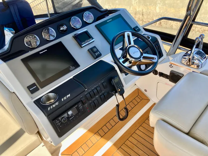  Yacht Photos Pics 2018 Sea Ray Fly 510 yacht helm with modern controls and navigation displays.