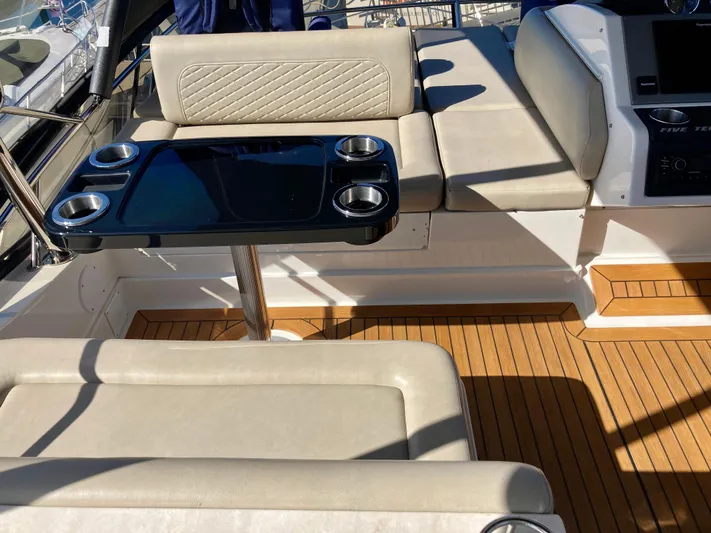  Yacht Photos Pics Luxurious seating area on 2018 Sea Ray Fly 510 yacht with sleek table and cup holders.
