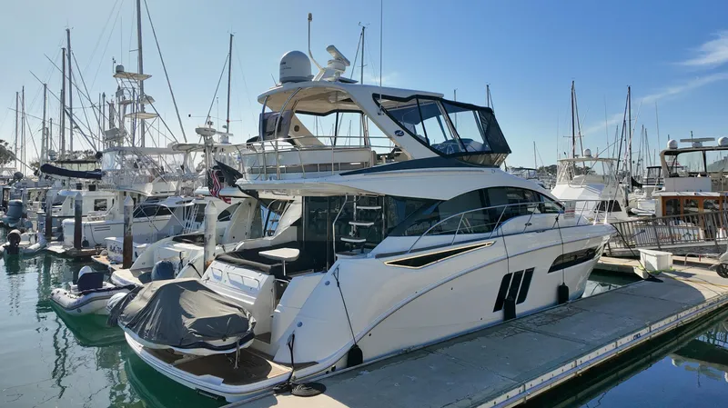  Yacht Photos Pics 2018 Sea Ray Fly 510 yacht docked in marina, surrounded by other boats.