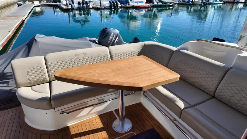  Yacht Photos Pics Luxurious 2018 Sea Ray Fly 510 yacht with elegant seating and wooden table in marina.