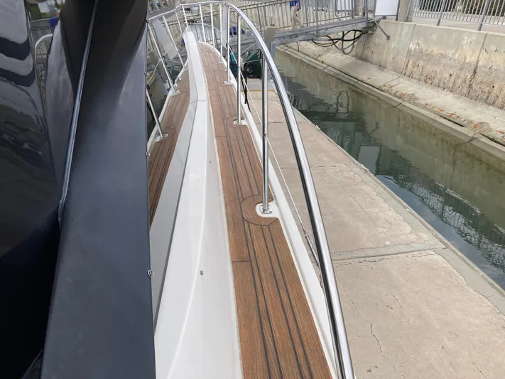  Yacht Photos Pics 2018 Sea Ray Fly 510 yacht docked, showcasing sleek deck and railing design.