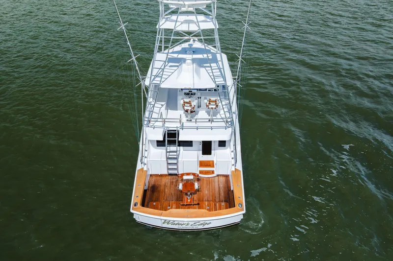 Water's Edge Yacht Photos Pics Aerial view of 2005 Hatteras Convertible 60 yacht on open water.