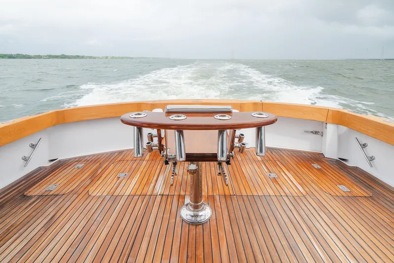 Water's Edge Yacht Photos Pics 2005 Hatteras Convertible 60 yacht deck with wooden flooring and ocean view.