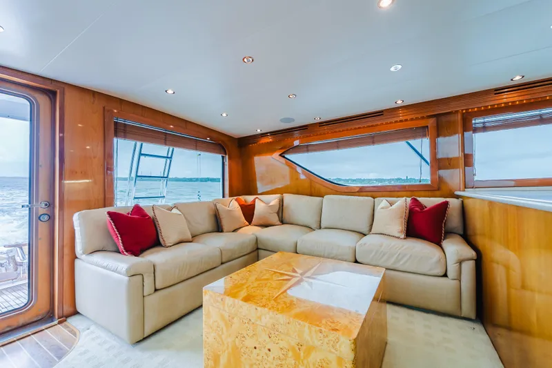 Water's Edge Yacht Photos Pics Luxurious interior of 2005 Hatteras Convertible 60 yacht with plush seating and ocean view.