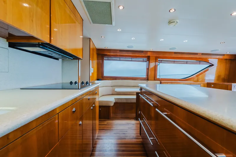 Water's Edge Yacht Photos Pics Luxurious interior of 2005 Hatteras Convertible 60 yacht with modern kitchen and seating area.