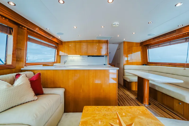 Water's Edge Yacht Photos Pics Luxurious interior of 2005 Hatteras Convertible 60 yacht with elegant wood finishes.