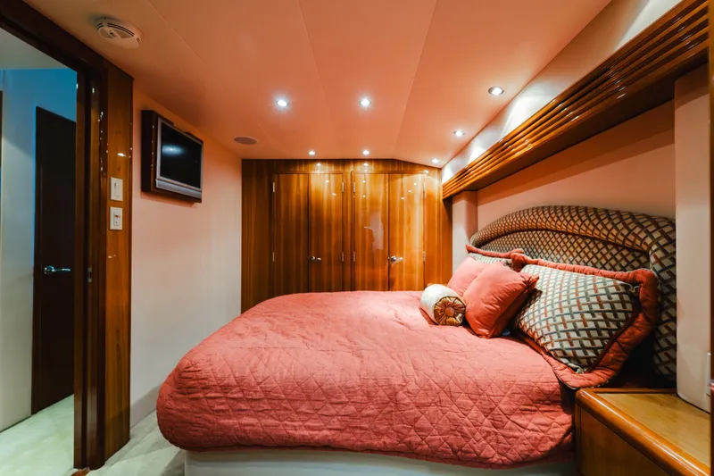 Water's Edge Yacht Photos Pics Luxurious bedroom interior of 2005 Hatteras Convertible 60 yacht with elegant wood finishes.