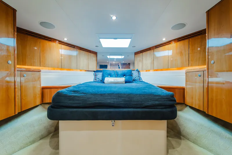 Water's Edge Yacht Photos Pics Luxurious cabin interior of 2005 Hatteras Convertible 60 yacht with elegant wood finish.