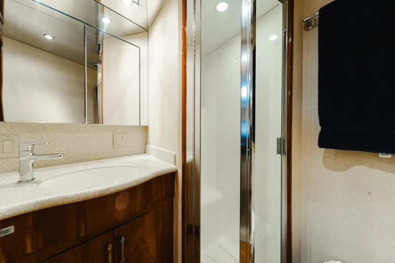 Water's Edge Yacht Photos Pics Luxurious bathroom in 2005 Hatteras Convertible 60 yacht with modern fixtures and shower.