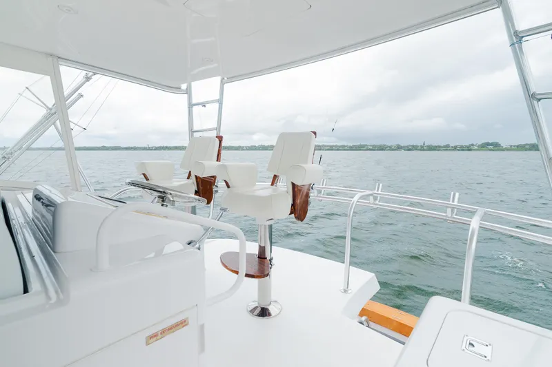 Water's Edge Yacht Photos Pics 2005 Hatteras Convertible 60 yacht interior with white seating and ocean view.